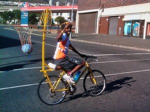 My real biking hero -Lala. On the same day Lance got paid an appearance fee to ride 109km around Cape Town and fly off in his private jet before the race was over. Lala did it to raise awareness for Hoops 4 Hope on 100 lb mountain bike with a busted seat post and bball hoop attached to the bike.